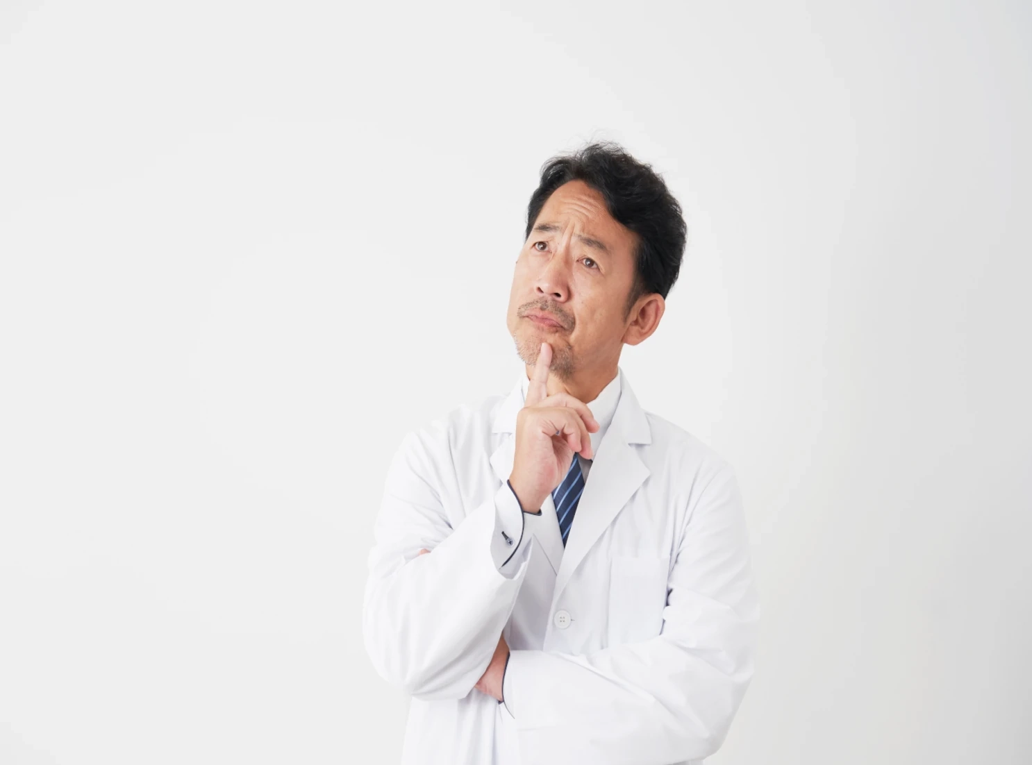 doctor with hand to chin thinking