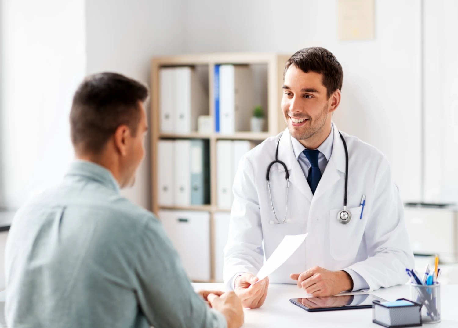doctor with patient showing paper
