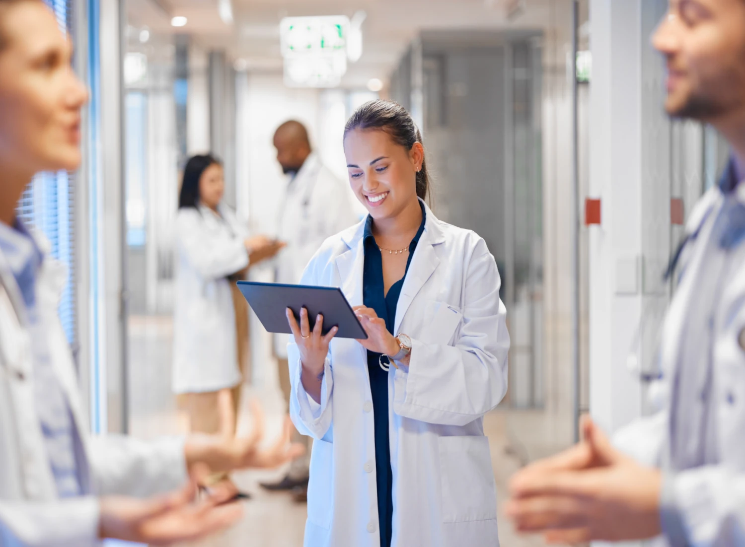 doctors talking together with tablet