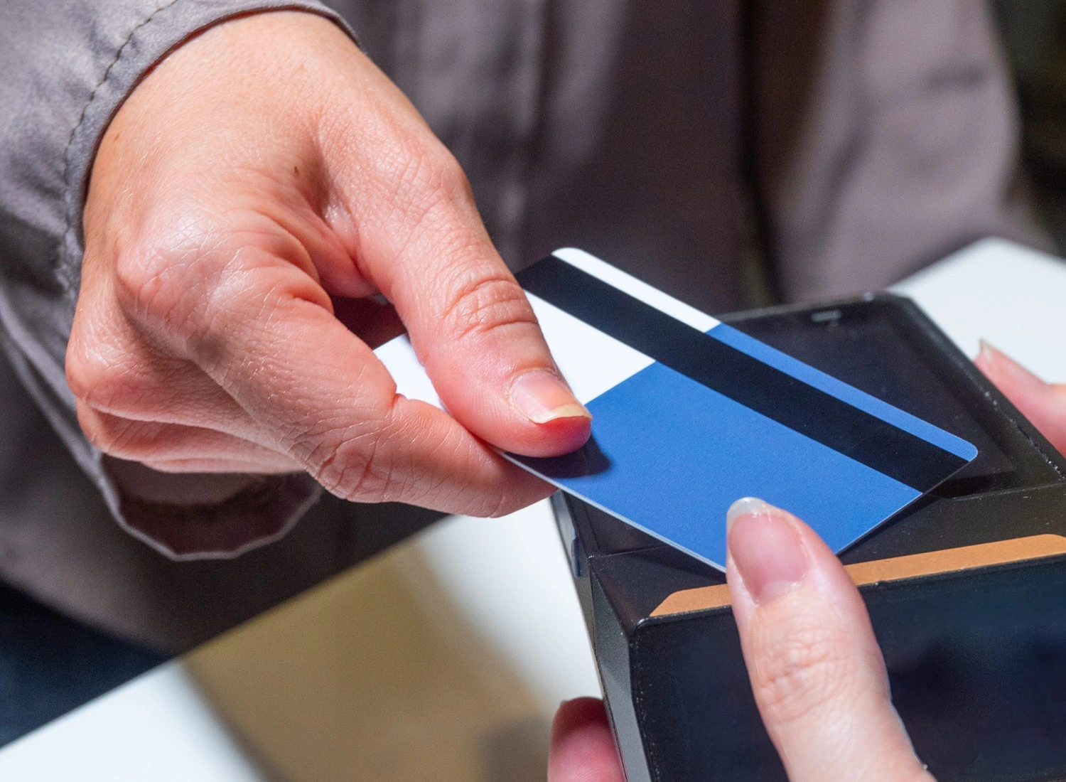 person tapping credit card