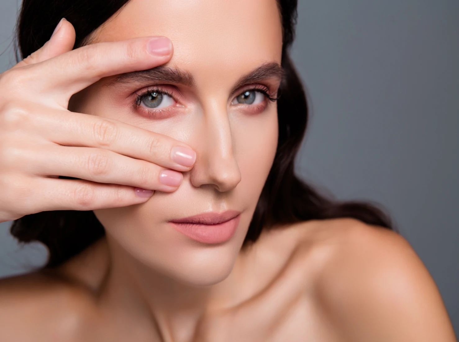 woman peering through hand