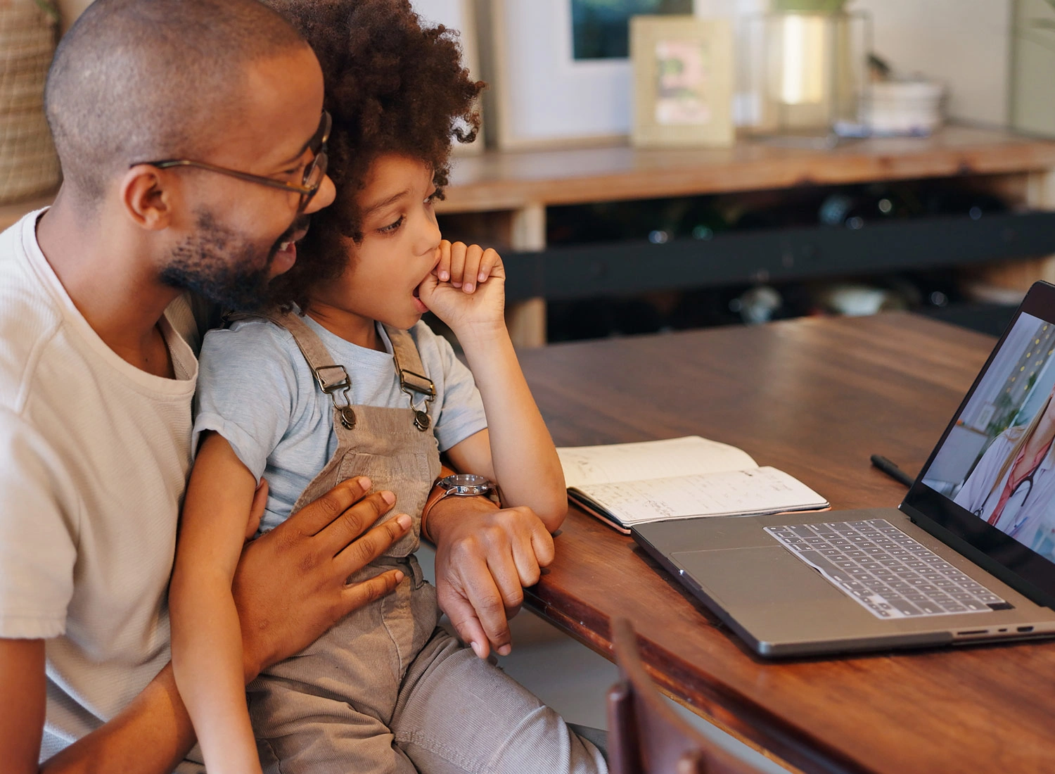 father and child on laptop