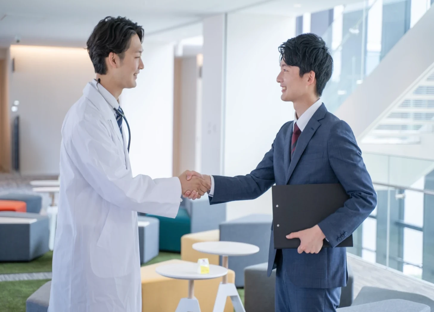 doctor shaking hands with a businessperson