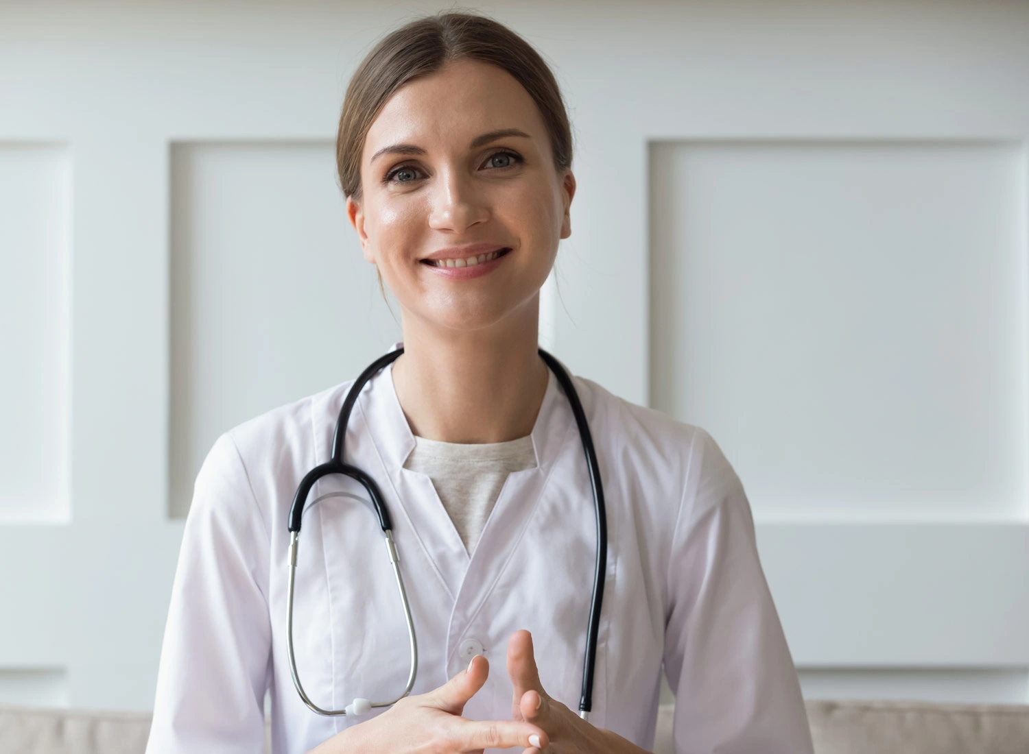 doctor smiling with hands together